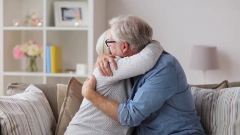 sad-senior-couple-hugging-at-home