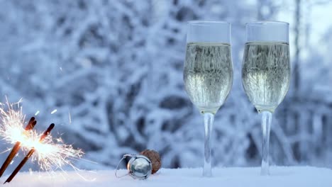 Sparklers-on-the-background-of-two-glasses,-in-winter