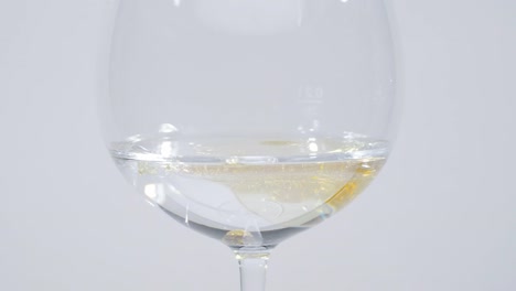 Squirt-of-Oil-Into-Water-in-Wine-Glass