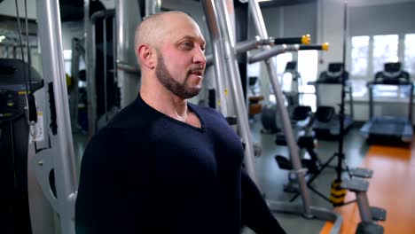 Adult-man-breathes-heavily-after-training-in-the-gym-4K-Slow-Mo