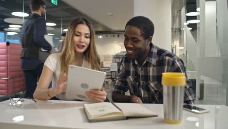 Business-Colleagues-with-Tablet-Discussing-Ideas