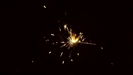 Firework-sparkler-burning-on-black-background-in-slow-motion