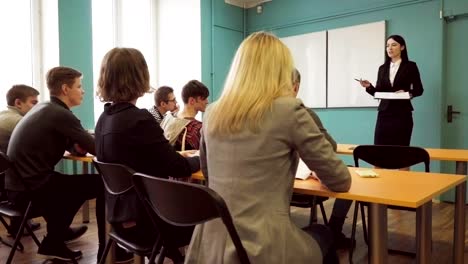 Students-raise-hands-after-the-teacher's-question-during-lecture