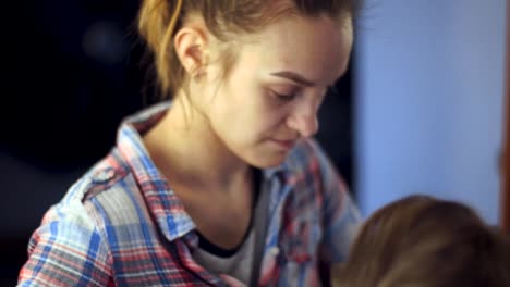 blonde-stylist-girl-makes-hairstyle-to-a-young-woman