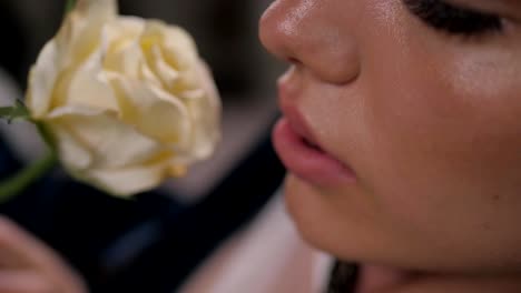 Close-up-shot-of-sexy-woman-lips-with-lipstick-and-beautiful-white-rose-sensual