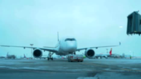 Tow-Tractor-towing-a-passenger-plane-on-the-runway-of-the-airfield