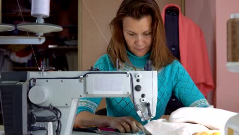 Sastre-mujer-trabajando-en-taller-de-confección.