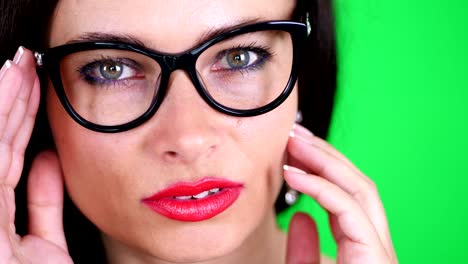 green-background,-chromeakey.-portrait-of-a-sexy-brunette-woman-with-red-lips,-in-stylish-glasses,-spectacles,-eroticly,-playfully-moves,-looking-sexually-at-camera,-posing-in-studio