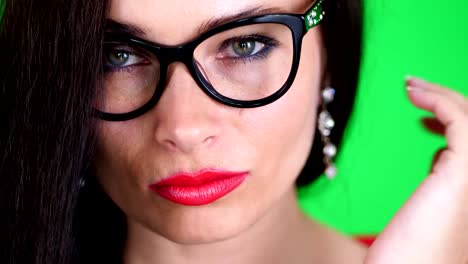 green-background,-chromeakey.-portrait-of-a-sexy-brunette-woman-with-red-lips,-in-stylish-glasses,-spectacles,-eroticly,-playfully-moves,-looking-sexually-at-camera,-posing-in-studio