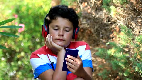 Young-boy-using-smartphone-at-the-oudoor