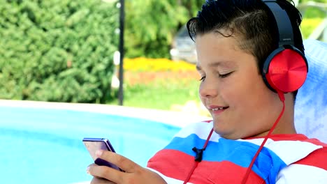 Young-boy-with-headphone-using-smartphone