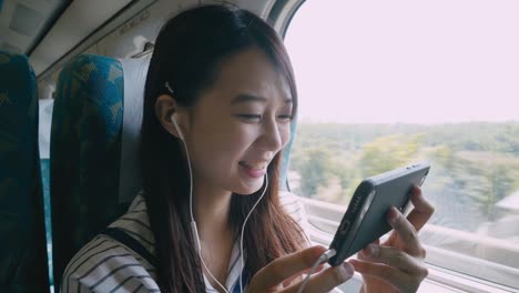 Woman-using-smartphone-on-train