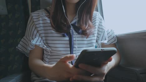 Woman-using-smartphone-on-train