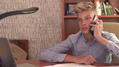 The-boy-is-talking-by-phone-in-bedroom