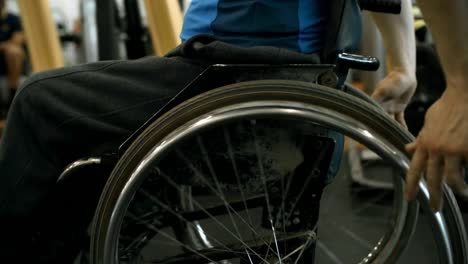 Unrecognizable-Man-in-Wheelchair-Riding-in-Gym