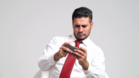 Businessman-playing-mobile-phone-games-during-office-hour.