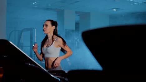 Sportswoman-runs-on-a-treadmill.-Close-up