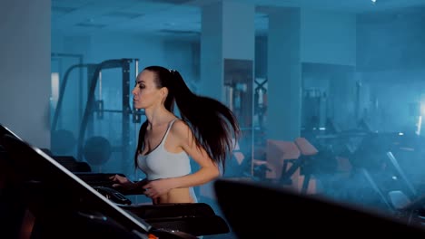 In-the-gym-a-beautiful-girl-runs.-Treadmill.-Close-up