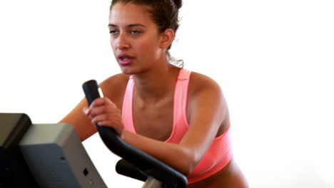 Fit-brunette-working-out-on-the-exercise-bike