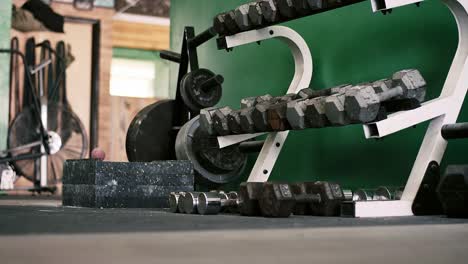 A-rack-of-dumbbells-in-a-small-gym-coming-into-focus