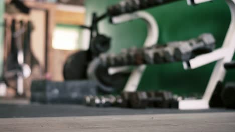 A-rack-of-dumbbells-in-a-small-gym-going-out-of-focus