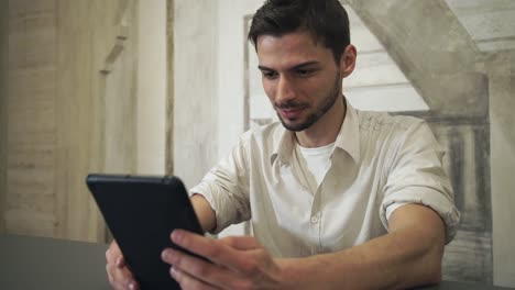 Portrait-man-using-app-on-touch-tablet-screen