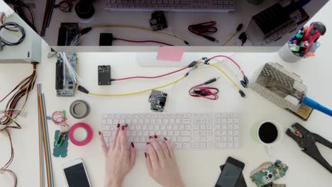 Female-electronics-engineer-typing-on-computer-keyboard