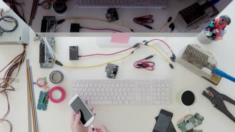 Female-electronics-technician-repairing-mobile-phone