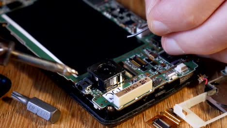 Soldering-smartphone-to-connect-two-contacts