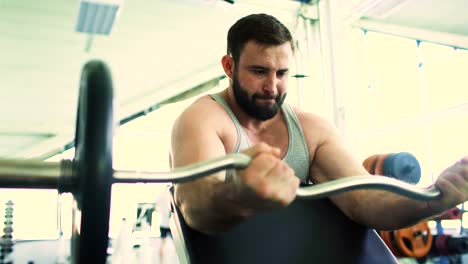 Handsome-sporty-man-is-exercising-in-fitness-club-and-gym-center