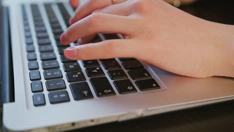 Female-Hands-Typing-Text-on-Laptop-Keyboard