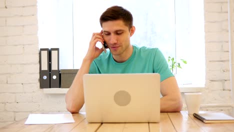 Man-Talking-on-Smart-Phone-in-His-Office