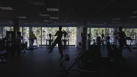 Footage-of-people's-silhouette-exercising-and-training-in-the-gym.