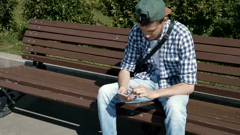 Young-handsome-man-browsing-internet-on-smartphone