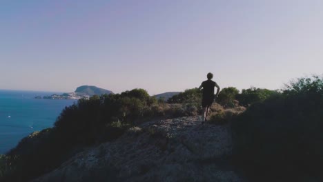 Running-man-arrives-on-top-of-a-cliff-on-an-island-and-exults