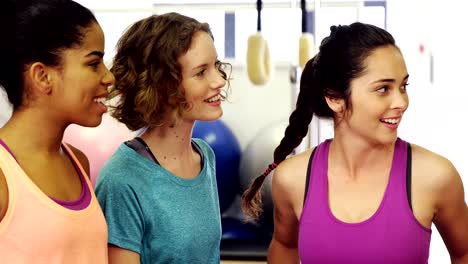 Beautiful-women-interacting-with-each-other-in-fitness-studio