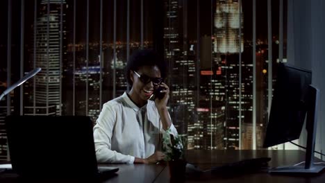 Smiling-woman-talking-phone-in-office