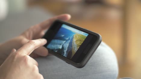 Closeup-Of-Woman-Browsing-Beach-Photos-On-Smartphone