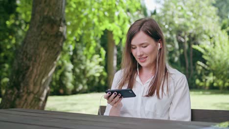 Young-Lady-Listening-to-Music-in-the-Park