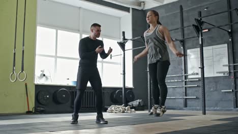 Personal-Coach-Motivating-Woman-During-Jump-Rope-Workout