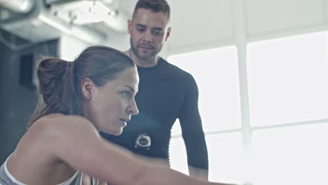 Woman-Swinging-Rope-at-personal-Workout-with-Coach