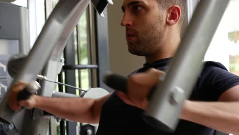 Young-man-doing-chest-exercise-at-gym