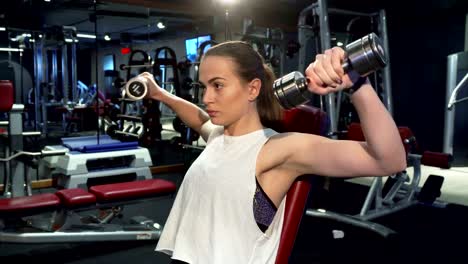 Athletic-girl-is-pumping-muscles-of-her-arms