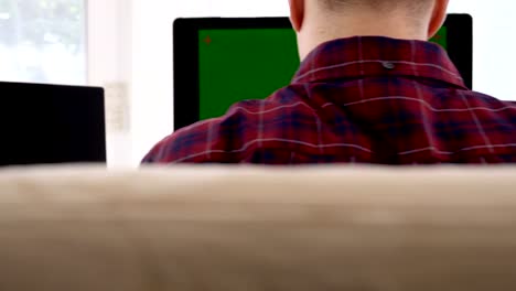 A-caucasian-male-typing-on-a-wireless-keyboard-on-the-wooden-table