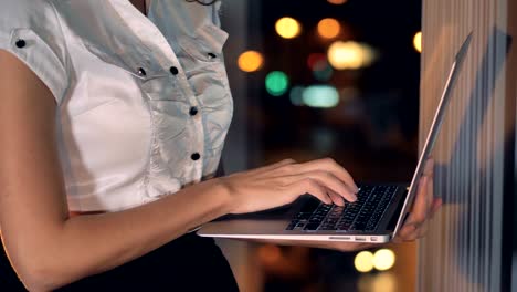 A-close-view-on-businesswomans-fingers-typing-at-a-laptop-keyboard.