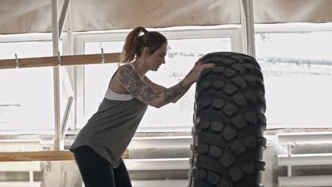 Athletic-Girl-Flipping-Large-Tractor-Tire