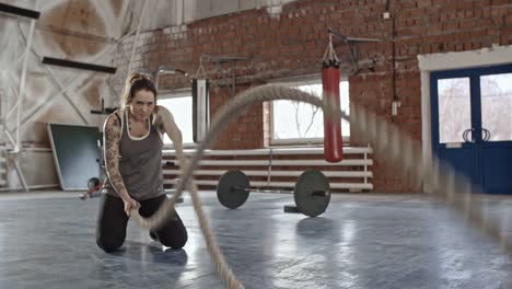 Muscular-Woman-Working-Out-with-Ropes