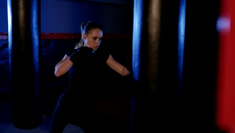 Girl-is-boxing.-Beautiful-kickboxing-woman-training-punching-bag