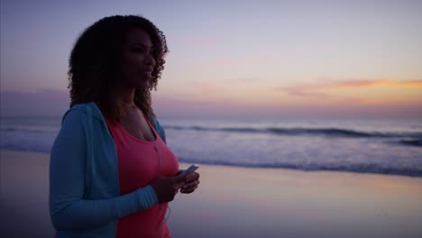 African-American-female-doing-walking-exercise-on-beach