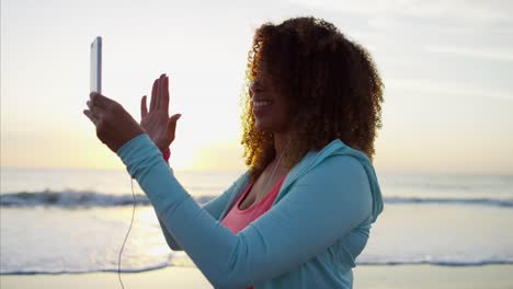 Ethnic-female-walking-at-sunset-in-sun-flare